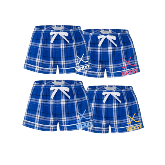 Blue plaid hockey shorts with hockey stick graphic, and 'HOCKEY' printed on left leg.