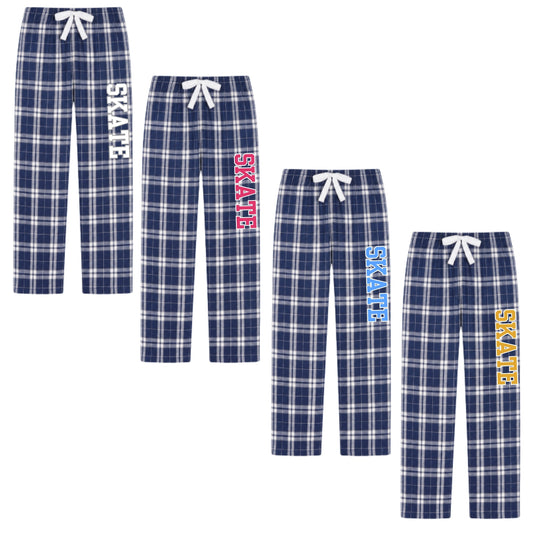 Four pairs of kids' plaid pajama pants in navy blue, white, and blue tones, each with a white drawstring and vertical 'SKATE' text printed on one leg in white, pink, light blue, or yellow.