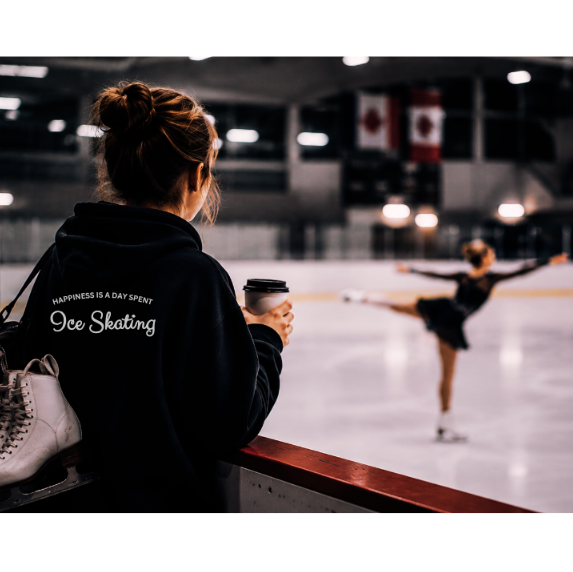 Head Figure Skating Coach enjoying a coffee and wearing customized Happiness is a day spent ice skating and watching her student.